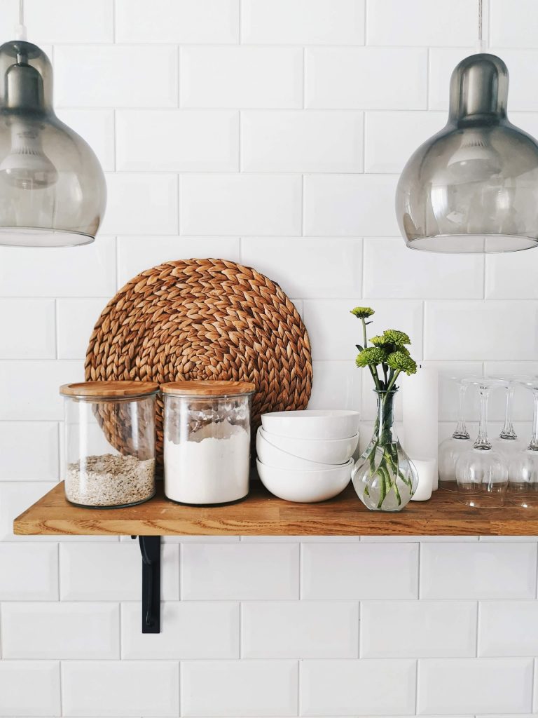 ways to revamp your kitchenl, potted plants along with wine glasses, bowls and jars placed on an open cabinet