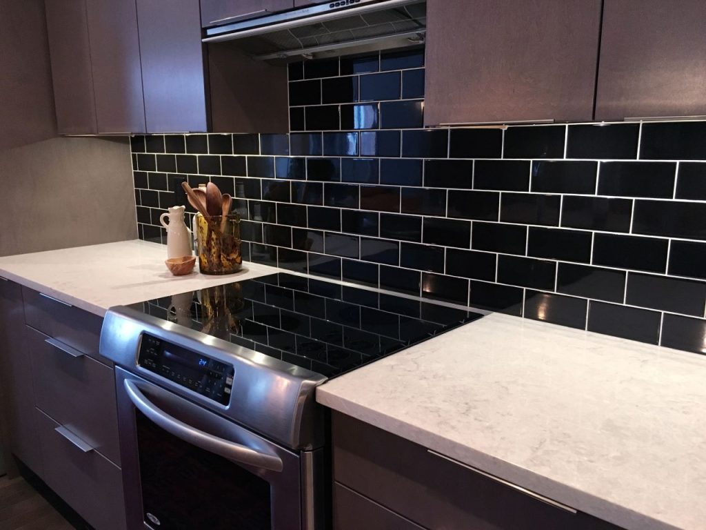 matte black kitchen design, a tiled black backsplash