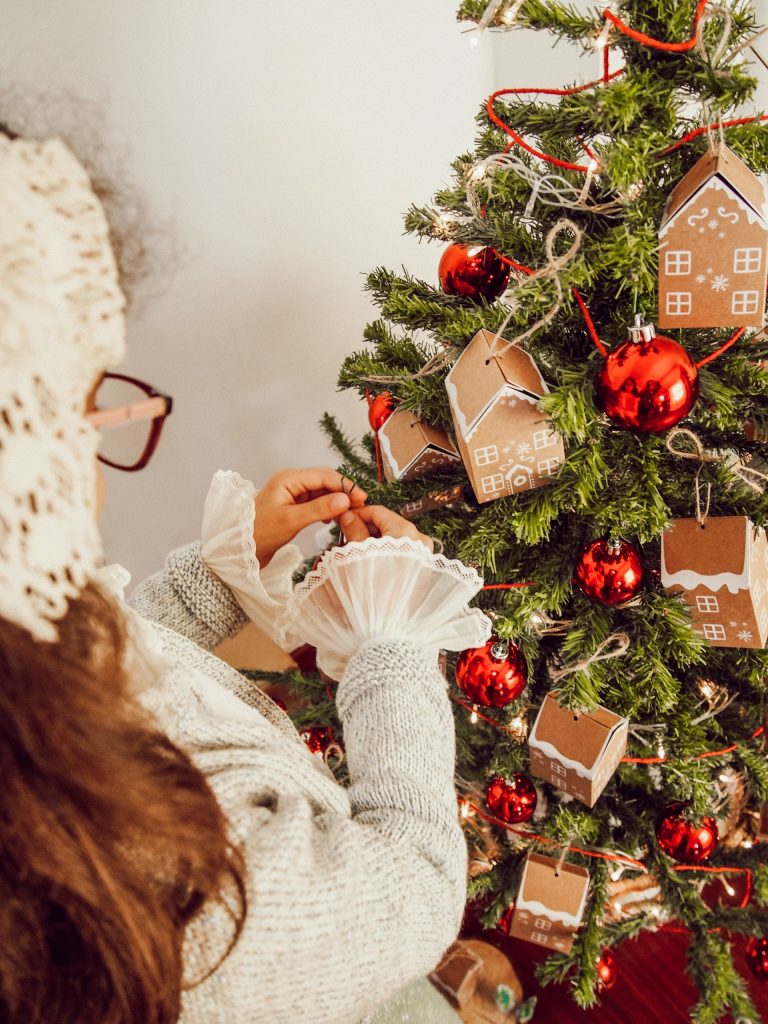 Girl decorating her Christmas tree