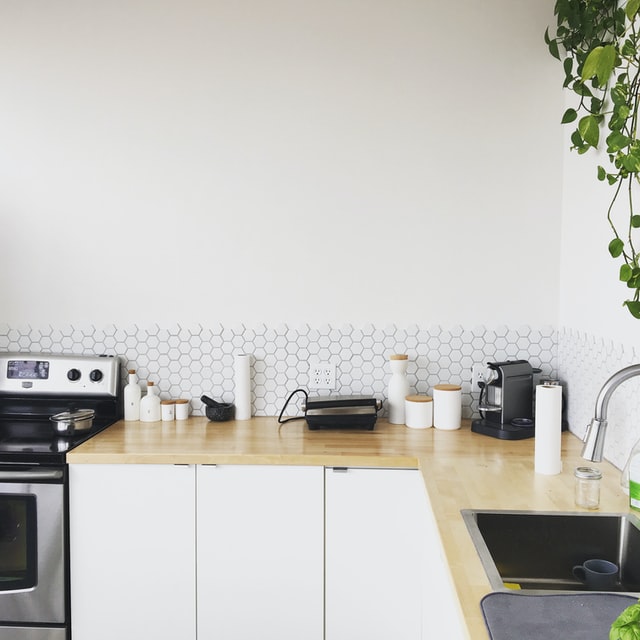 Polyester countertop with a toaster, coffee maker and small jars placed on it